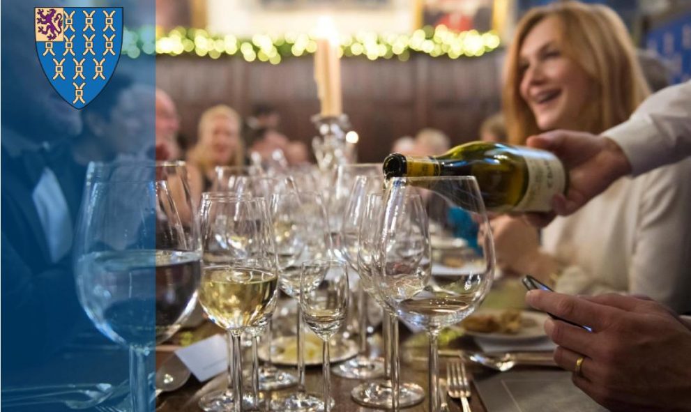 image of wine being poured into glasses at dining table