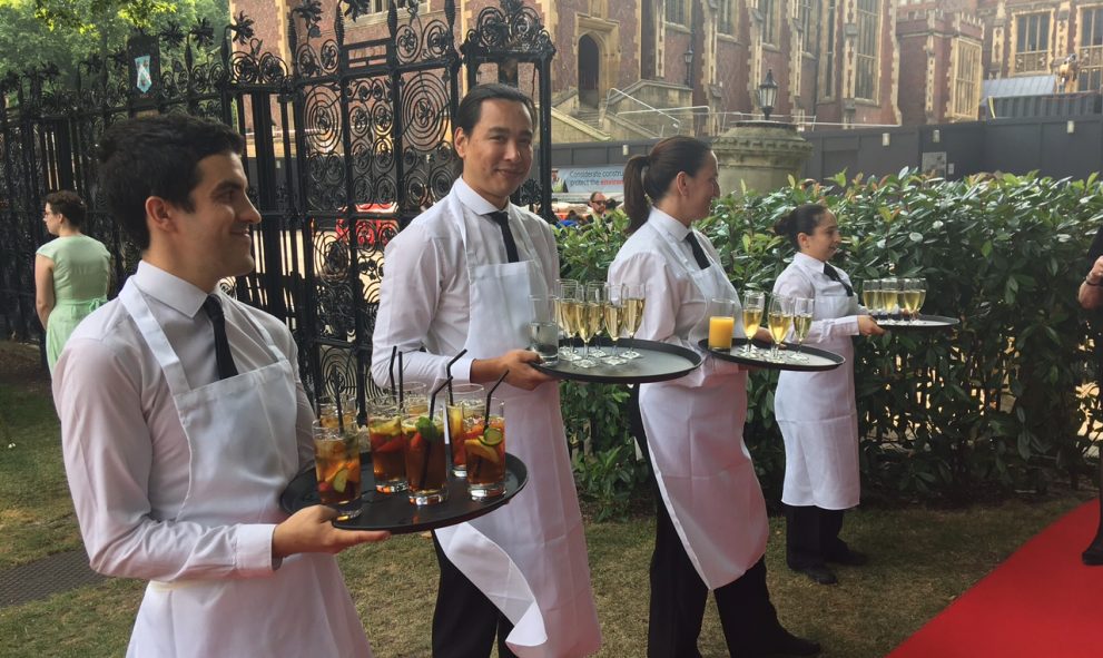 waiting staff serving drinks on red carpet in New Square