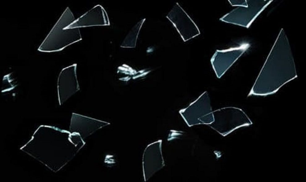 splintering glass on black background