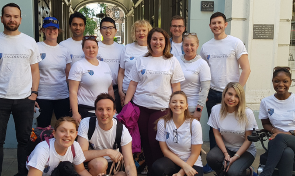 Team of people wearing Lincoln's Inn t-shirts, smiling